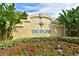 The Inlets at Riverdale entrance sign surrounded by lush greenery and colorful flowers at 4532 Shark Dr, Bradenton, FL 34208