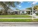 Charming single-story home with lush lawn, mature trees, and a covered carport on a sunny day at 4532 Shark Dr, Bradenton, FL 34208