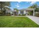 Charming home with manicured lawn, lush landscaping, and covered parking at 4532 Shark Dr, Bradenton, FL 34208