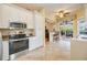Modern kitchen with stainless steel appliances, white cabinets, and tile flooring at 4532 Shark Dr, Bradenton, FL 34208