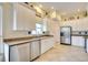 Bright kitchen with stainless steel appliances, tile floors and white cabinets at 4532 Shark Dr, Bradenton, FL 34208