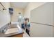 A laundry room with a sink, washer, dryer, shelving, and a refrigerator at 4532 Shark Dr, Bradenton, FL 34208