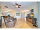Open living room with hardwood floors, ceiling fan and a large mirror wall at 4532 Shark Dr, Bradenton, FL 34208