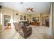 Comfortable living room featuring ceiling fan and leather reclining sofas at 4532 Shark Dr, Bradenton, FL 34208