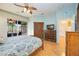 Spacious main bedroom with a ceiling fan, wood flooring, and sliding doors to the outdoors at 4532 Shark Dr, Bradenton, FL 34208