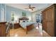 Bright main bedroom with a ceiling fan, wood flooring, and sliding doors to the outdoors at 4532 Shark Dr, Bradenton, FL 34208