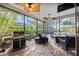Covered patio with brick flooring, a ceiling fan, and a grill, overlooking the pool at 4532 Shark Dr, Bradenton, FL 34208