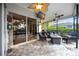 Screened in patio with a ceiling fan, a TV, and a fire pit with outdoor furniture at 4532 Shark Dr, Bradenton, FL 34208