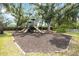 Community playground with slides, play structures, and a wood chip safety surface at 4532 Shark Dr, Bradenton, FL 34208