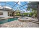 Gorgeous screen enclosed pool with raised spa, brick pavers, outdoor lounge, and dining area at 4532 Shark Dr, Bradenton, FL 34208