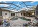 Beautiful screened-in pool with a spa, brick paver deck, and comfortable patio furniture at 4532 Shark Dr, Bradenton, FL 34208