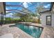 Enclosed pool featuring a spa and a seating area in a screen enclosed lanai at 4532 Shark Dr, Bradenton, FL 34208