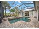 Inviting screened-in pool area featuring a spa and outdoor seating, perfect for relaxation at 4532 Shark Dr, Bradenton, FL 34208