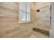 Wood look tile shower with bench and window for natural light at 4532 Shark Dr, Bradenton, FL 34208