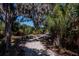 Community pea gravel walking trail through natural landscaping and mature trees at 4532 Shark Dr, Bradenton, FL 34208