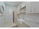 Modern laundry room with white cabinets, granite countertops, and farmhouse sink at 4607 5Th Ne Ave, Bradenton, FL 34208