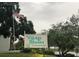 Village Brooke Condominiums sign with American flag at 3271 Beneva Rd # 204, Sarasota, FL 34232