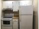 Galley kitchen with white cabinets and appliances at 3271 Beneva Rd # 204, Sarasota, FL 34232