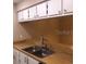 Kitchen sink and countertops with white cabinets at 3271 Beneva Rd # 204, Sarasota, FL 34232