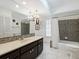 Updated bathroom with shower/tub and dark vanity at 302 Mendez Dr, Sarasota, FL 34243