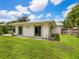 House exterior view, showcasing a large grassy backyard at 302 Mendez Dr, Sarasota, FL 34243