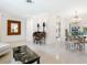 Open living and dining area with tiled floors and large mirror at 302 Mendez Dr, Sarasota, FL 34243