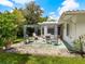 Relaxing backyard patio with pergola and seating area, perfect for outdoor entertaining at 302 Mendez Dr, Sarasota, FL 34243