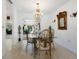 Elegant dining room with chandelier and glass-top table at 302 Mendez Dr, Sarasota, FL 34243