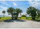 Scenic waterfront view with palm trees and calm water at 302 Mendez Dr, Sarasota, FL 34243