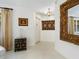 Clean and bright entryway with a unique side table and ornate mirror at 302 Mendez Dr, Sarasota, FL 34243