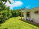 Landscaped backyard with lush greenery and a small sitting area at 302 Mendez Dr, Sarasota, FL 34243