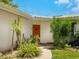 Front entrance with terracotta door and drought-tolerant landscaping at 302 Mendez Dr, Sarasota, FL 34243