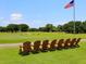 Peaceful view of a golf course with Adirondack chairs at 302 Mendez Dr, Sarasota, FL 34243