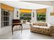 Cozy sitting area with a floral sofa and backyard access at 302 Mendez Dr, Sarasota, FL 34243