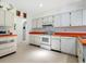 Bright kitchen with white cabinets and orange countertops at 302 Mendez Dr, Sarasota, FL 34243