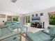 Spacious living room featuring comfortable seating and a large TV at 302 Mendez Dr, Sarasota, FL 34243