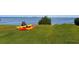 Two kayaks on the grass near waterfront, suggesting water activities at 302 Mendez Dr, Sarasota, FL 34243