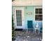 Inviting front porch with teal chairs and unique decor at 1603 Gulf N Dr # 5, Bradenton Beach, FL 34217