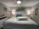King-size bed, beach decor and ceiling fan in this bedroom at 1603 Gulf N Dr # 5, Bradenton Beach, FL 34217