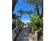Wooden walkway leads to beach through lush foliage, offering a relaxing and private access at 1603 Gulf N Dr # 5, Bradenton Beach, FL 34217