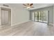 Bedroom with wood-look floors, ceiling fan and access to balcony at 515 30Th W Ave # H201, Bradenton, FL 34205