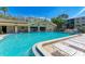 Inviting community pool with ample lounge chairs for relaxation at 515 30Th W Ave # H201, Bradenton, FL 34205