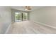 Bright bedroom with wood-look floors and balcony access at 515 30Th W Ave # H201, Bradenton, FL 34205