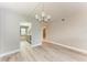Condo dining room with chandelier and view of kitchen at 515 30Th W Ave # H201, Bradenton, FL 34205