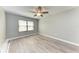 Well-lit bedroom with ceiling fan and wood-look flooring at 515 30Th W Ave # H201, Bradenton, FL 34205