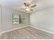 Bedroom with wood-look floors, ceiling fan and window at 515 30Th W Ave # H201, Bradenton, FL 34205