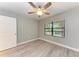 Bedroom with wood-look floors, ceiling fan and private bathroom at 515 30Th W Ave # H201, Bradenton, FL 34205