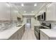 Modern galley kitchen with stainless steel appliances and white cabinets at 515 30Th W Ave # H201, Bradenton, FL 34205