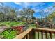 Peaceful pond-view from a wooden deck, showcasing lush landscaping at 515 30Th W Ave # H201, Bradenton, FL 34205