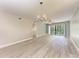 Living room features wood-look floors, balcony access at 515 30Th W Ave # H201, Bradenton, FL 34205